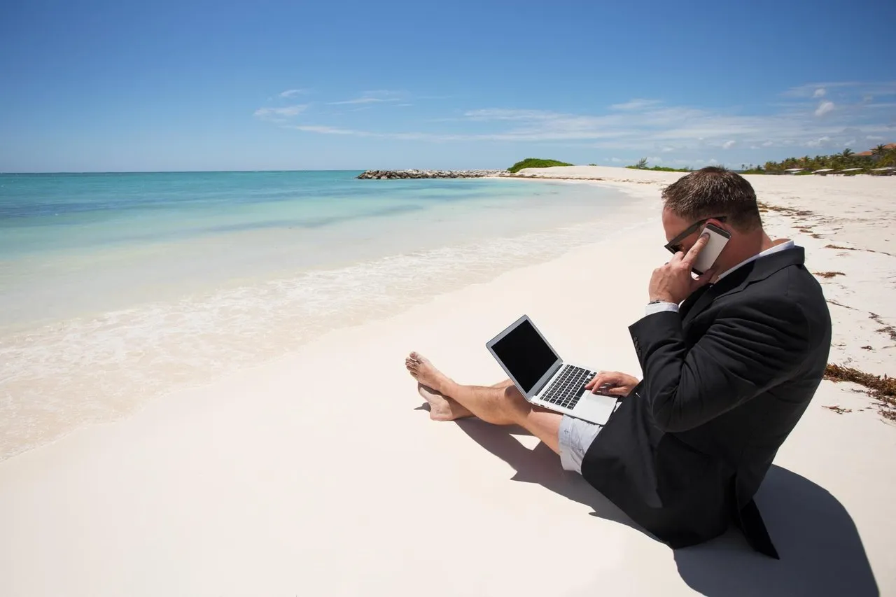 Working on a laptop right on a Fiji beach